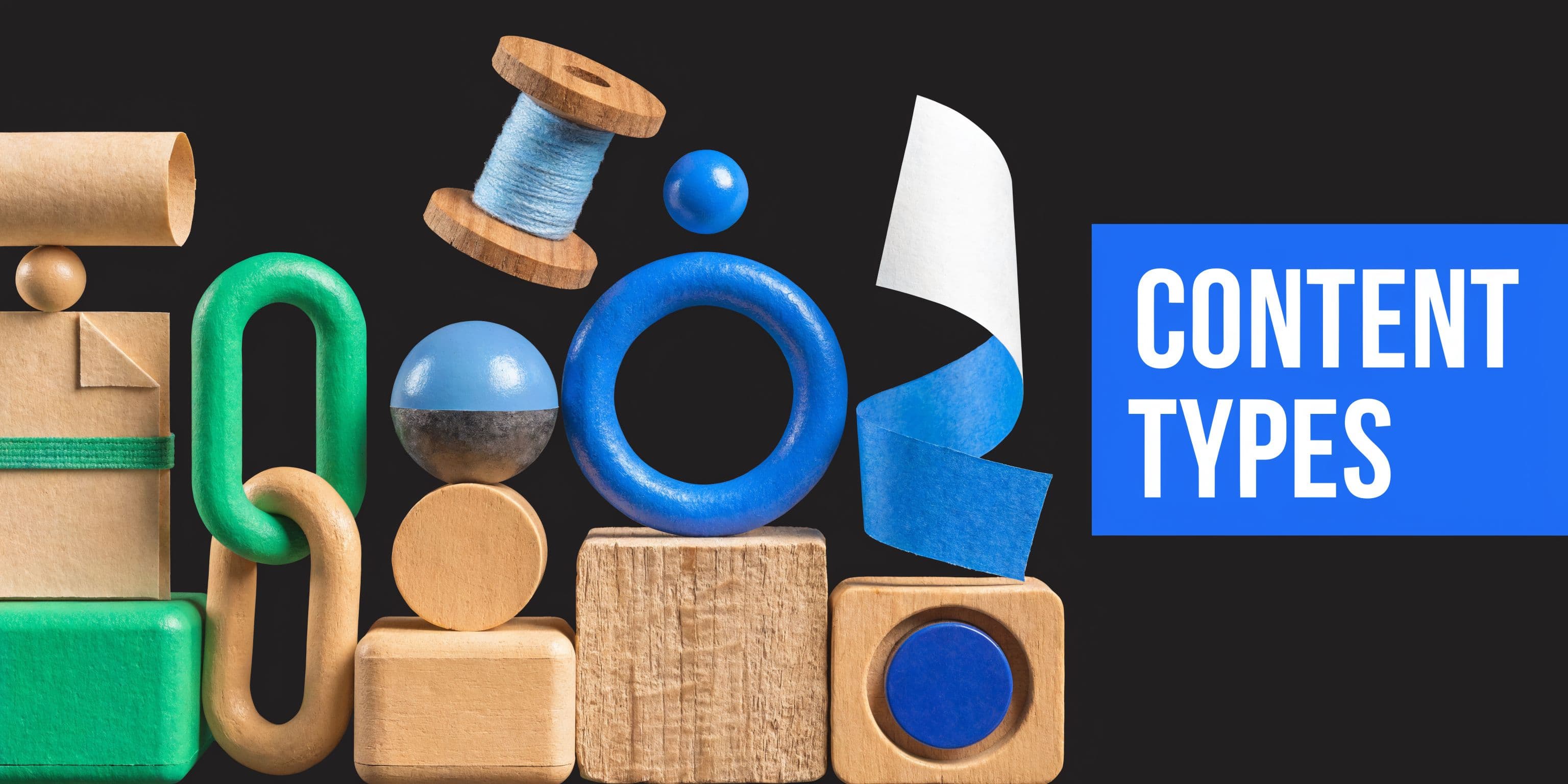A creative composition featuring various wooden and paper craft shapes alongside the blue text content types.