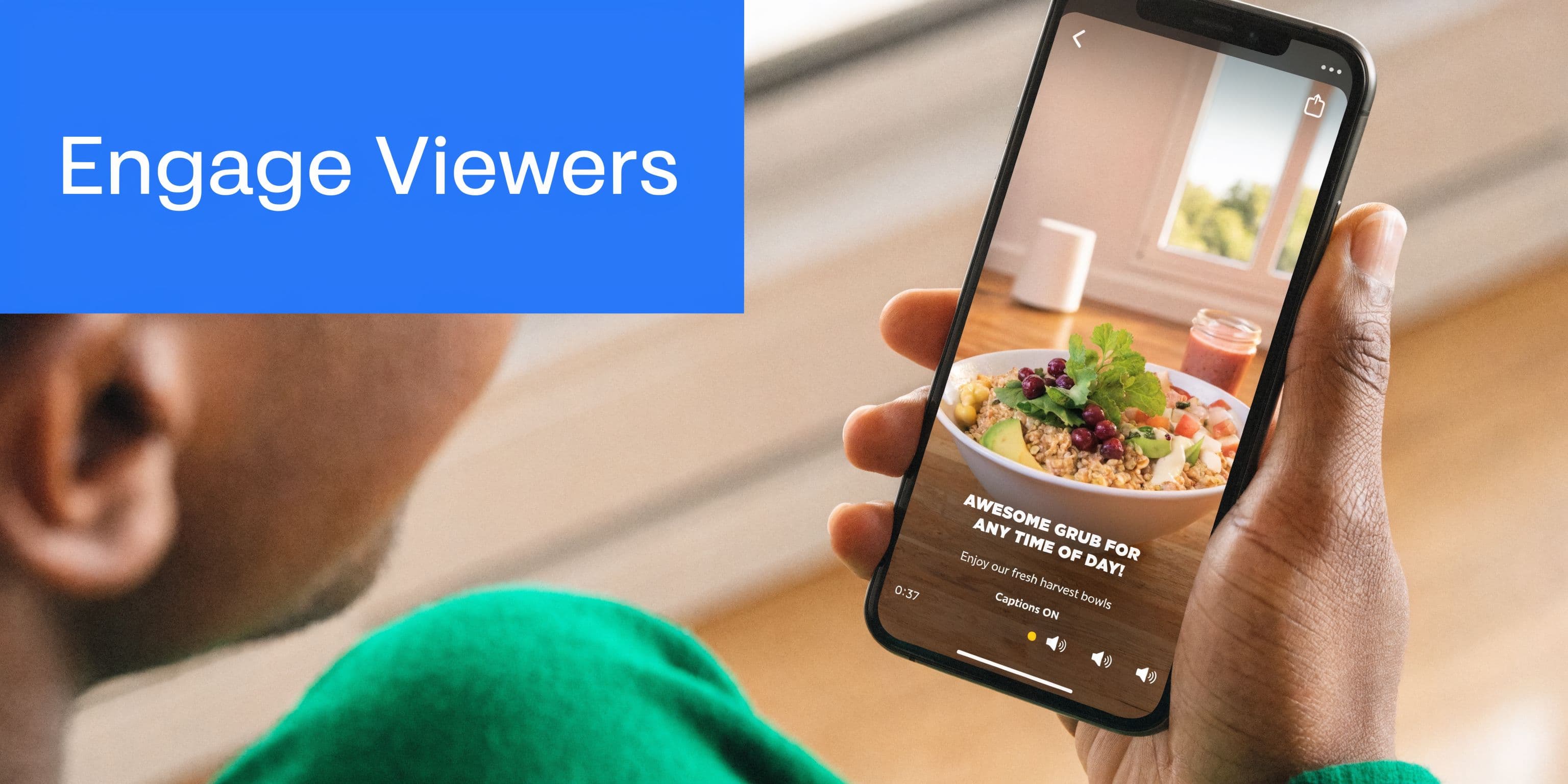 A person holding a smartphone showing a food video on a social media interface with captions.